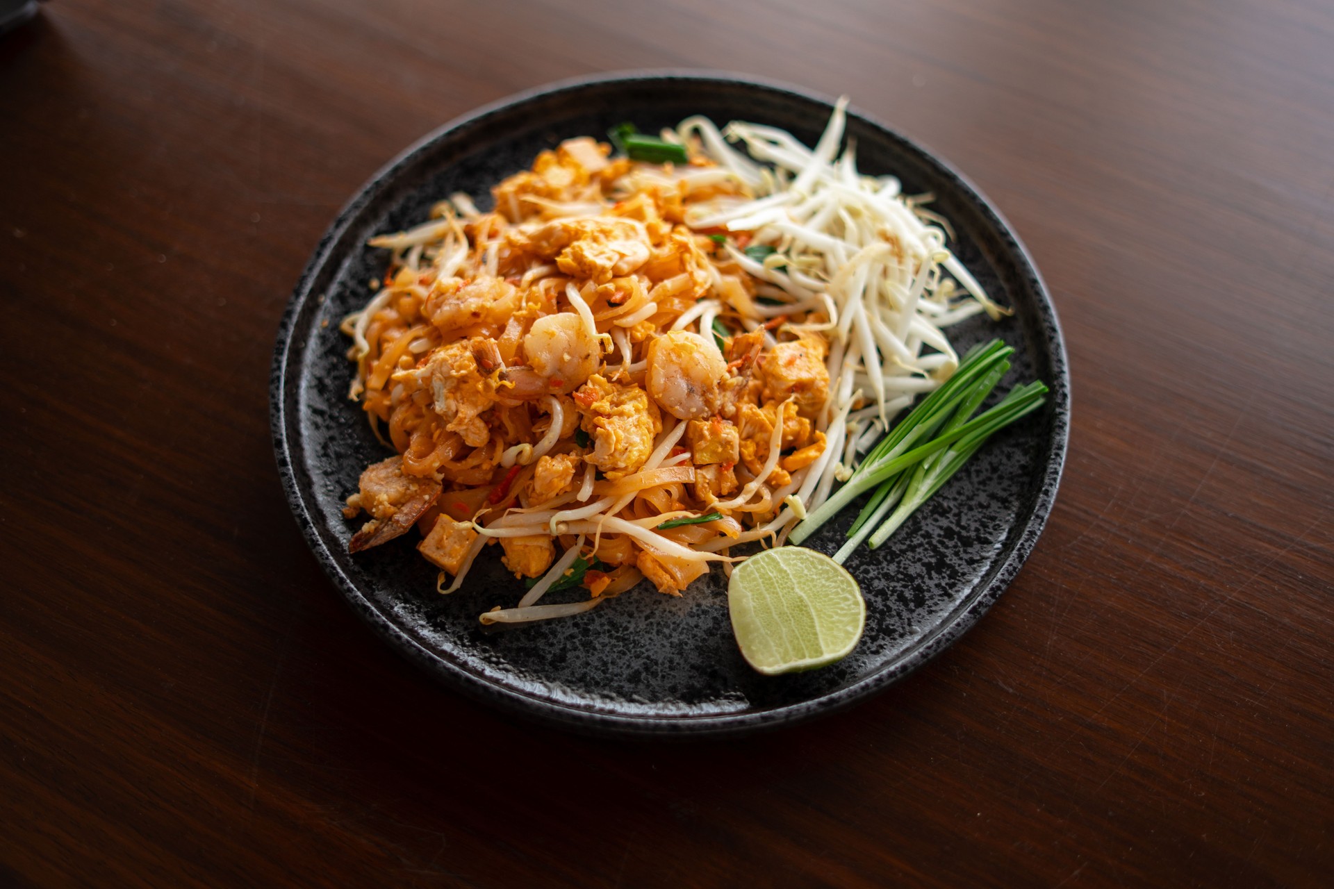 Pad Thai from the market placed on a plate on the table at home.